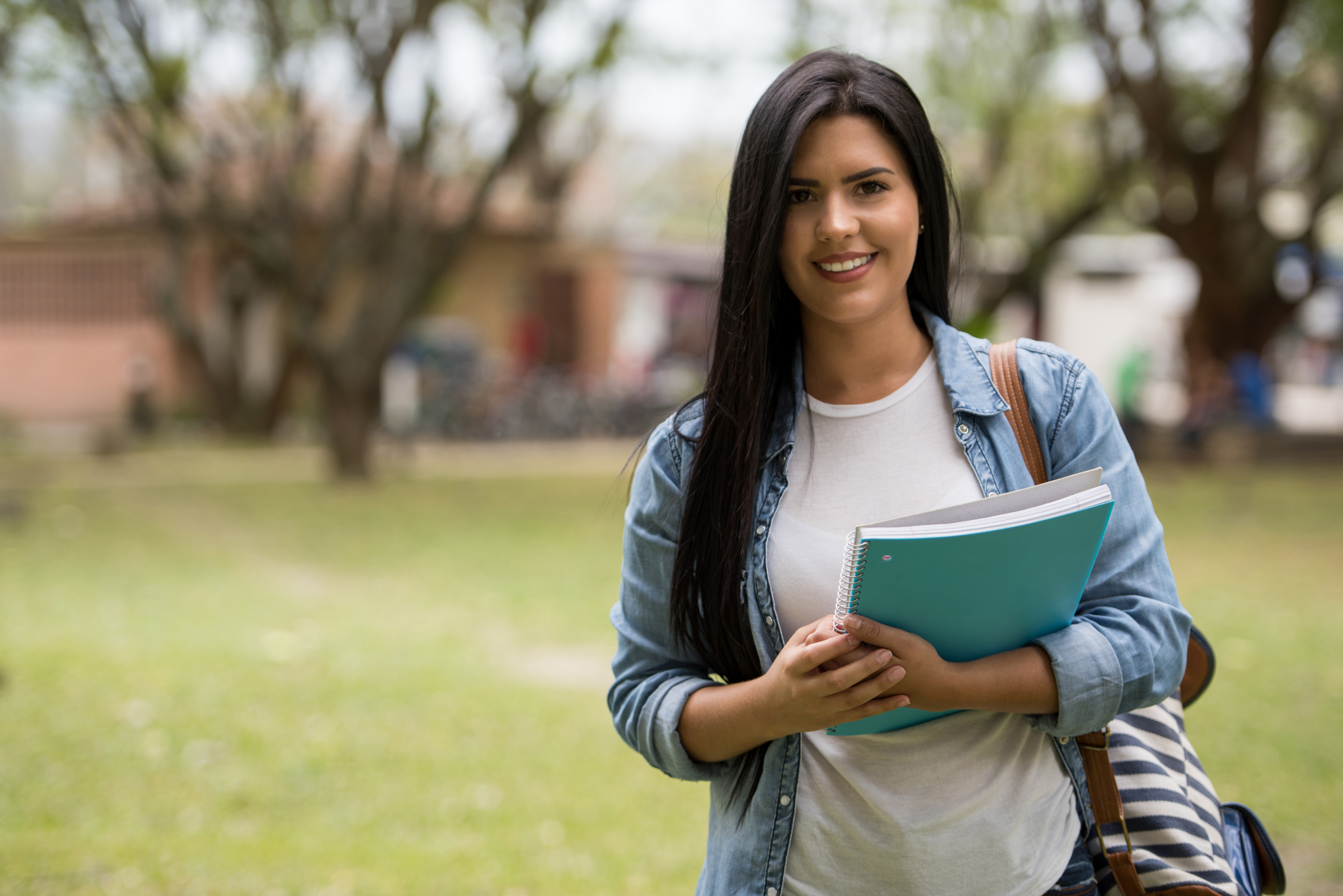 Student with FGC shirt standing outside on campus