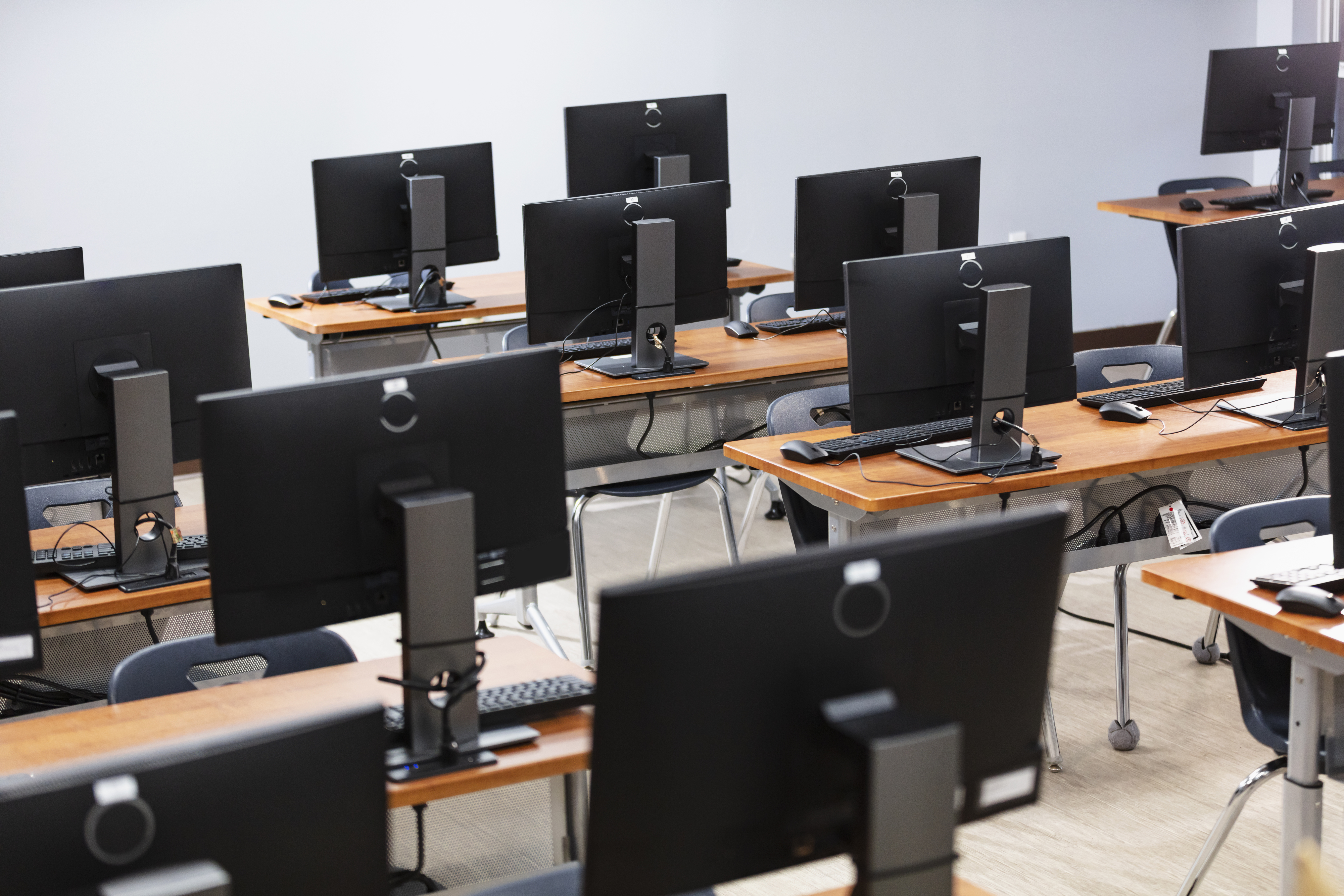 computer lab with rows of desks computer lab with rows of desks