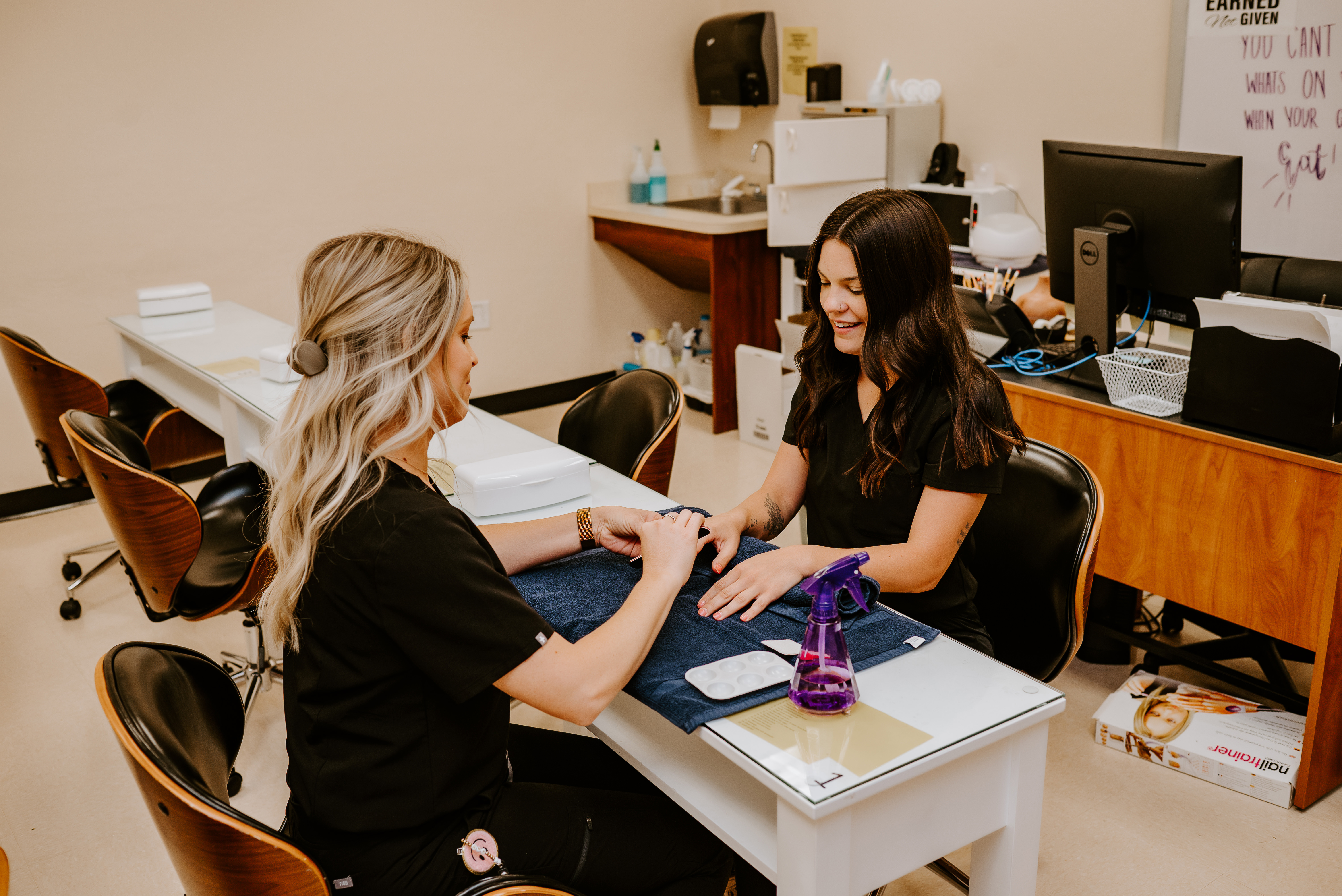 Cosmetology students performing nail service