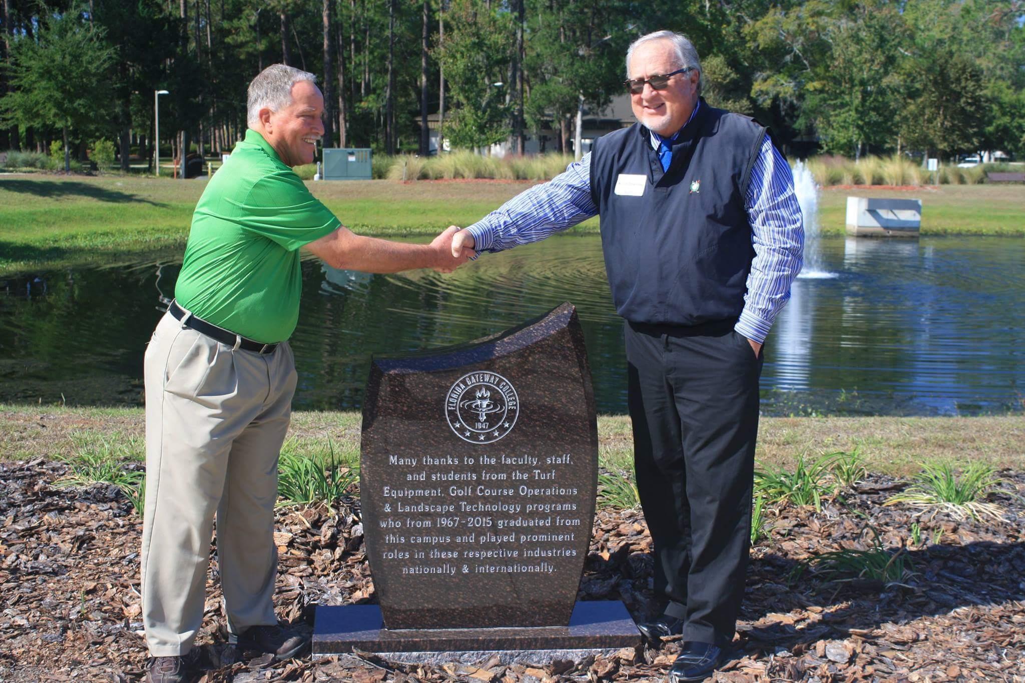 The dedication signified the shift from on-campus golf and landscape programs to an online Horticultural program. The individuals pictured are John Piersol, the long-serving director, and Kevin Downing, CGCS, an alumnus of the program. Both individuals actively participate on the advisory committee for the golf programs at FGC.