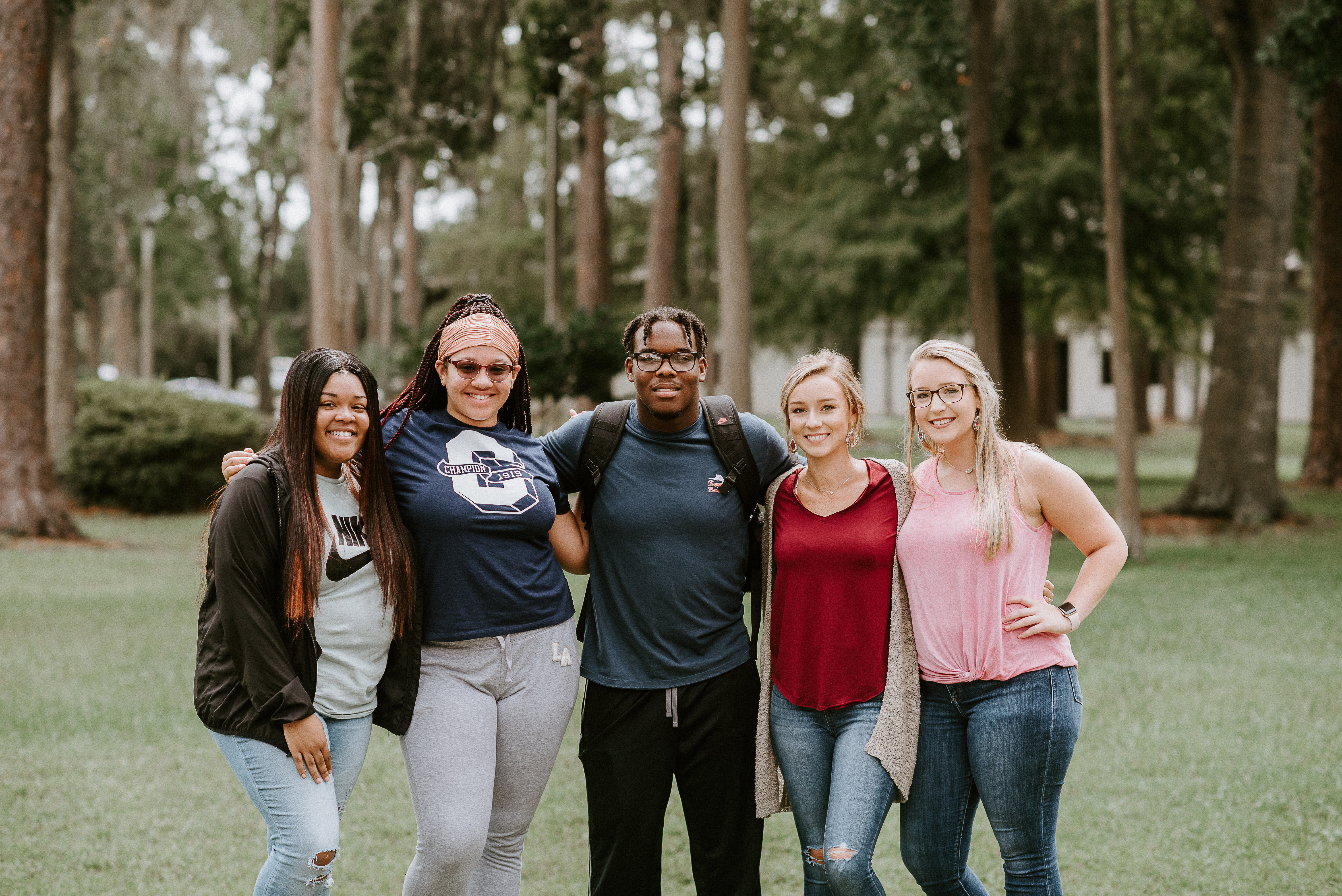 Students linking arms outside on campus