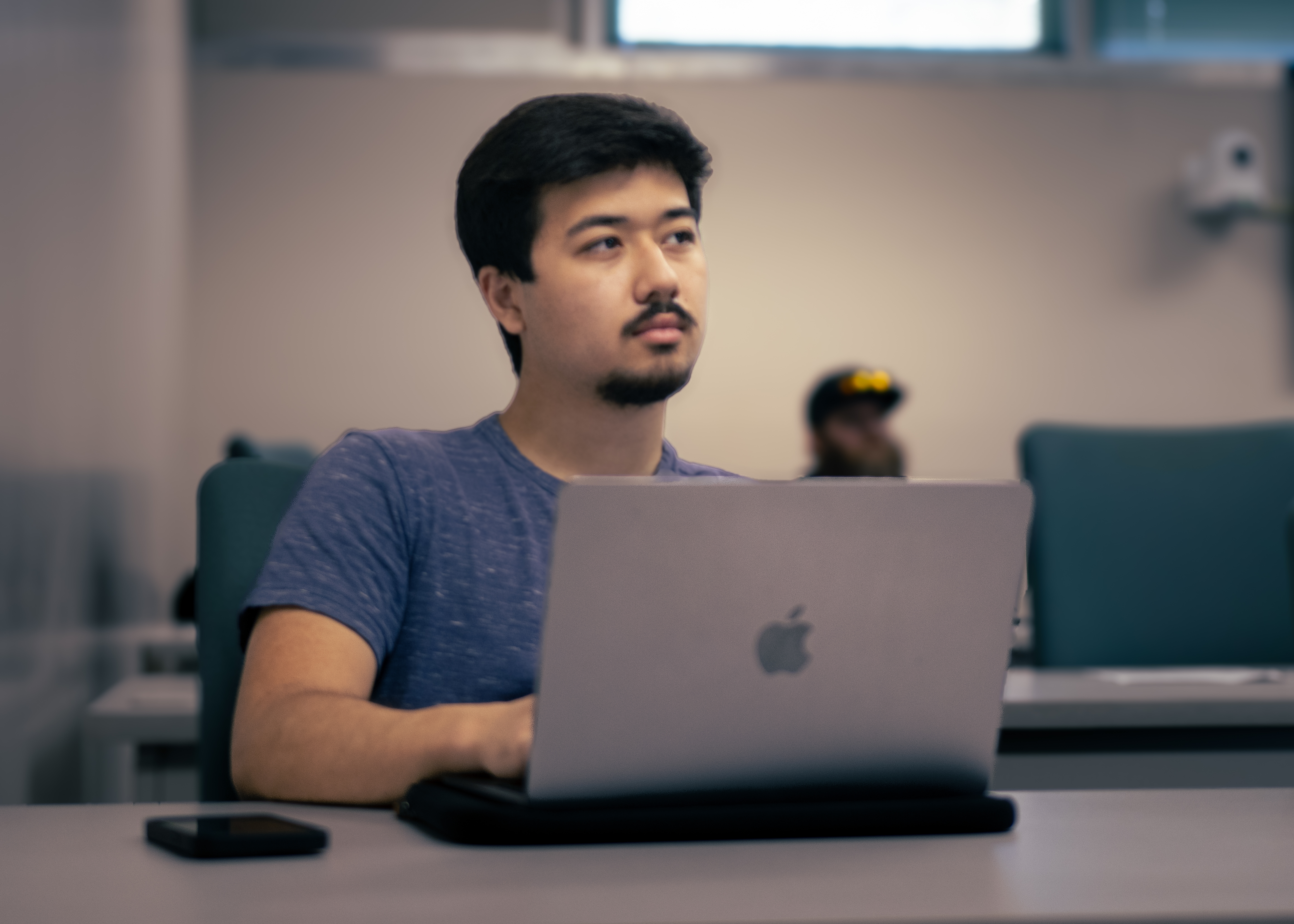 Business Student in classroom on laptop