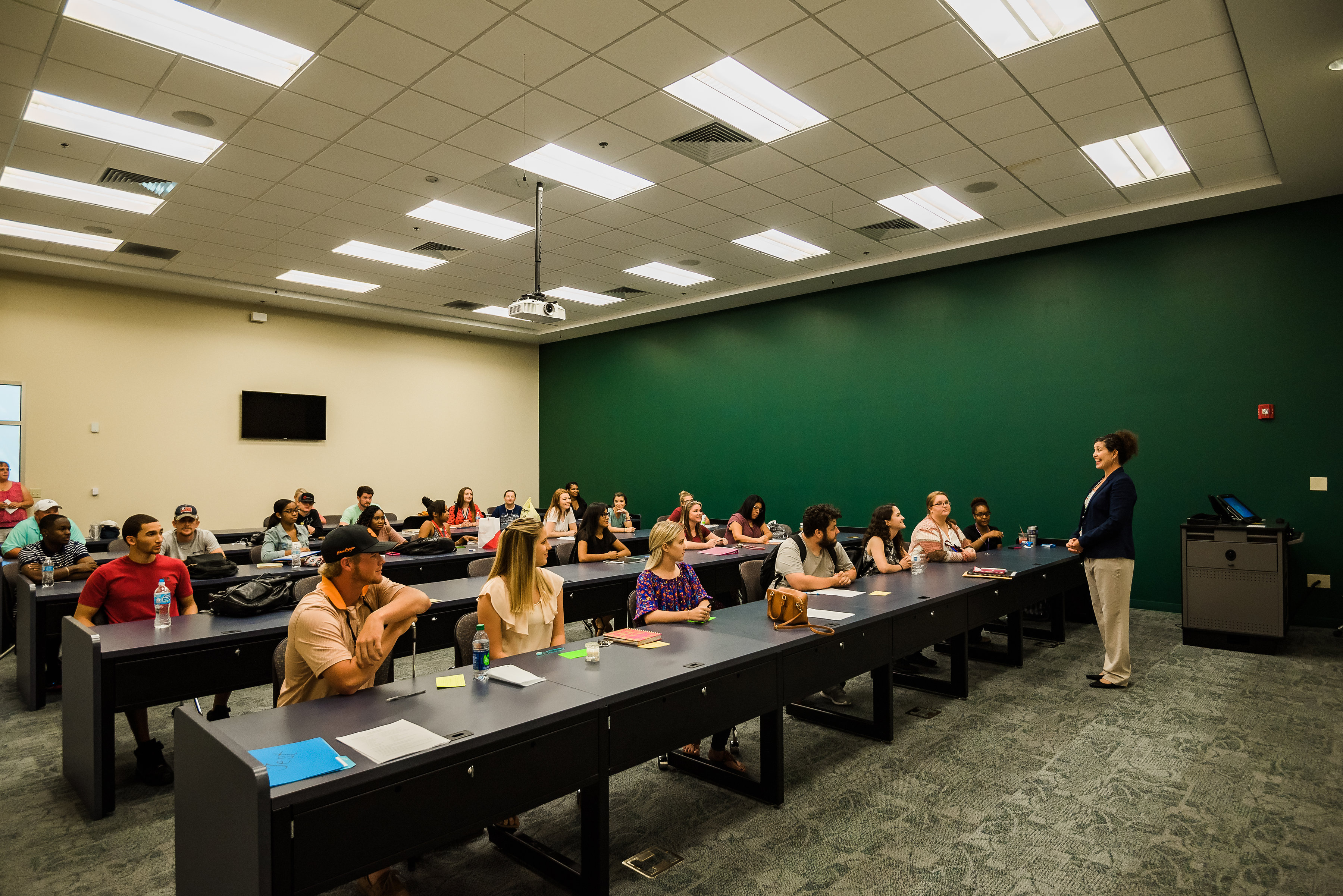 Student listening to professor in classroom