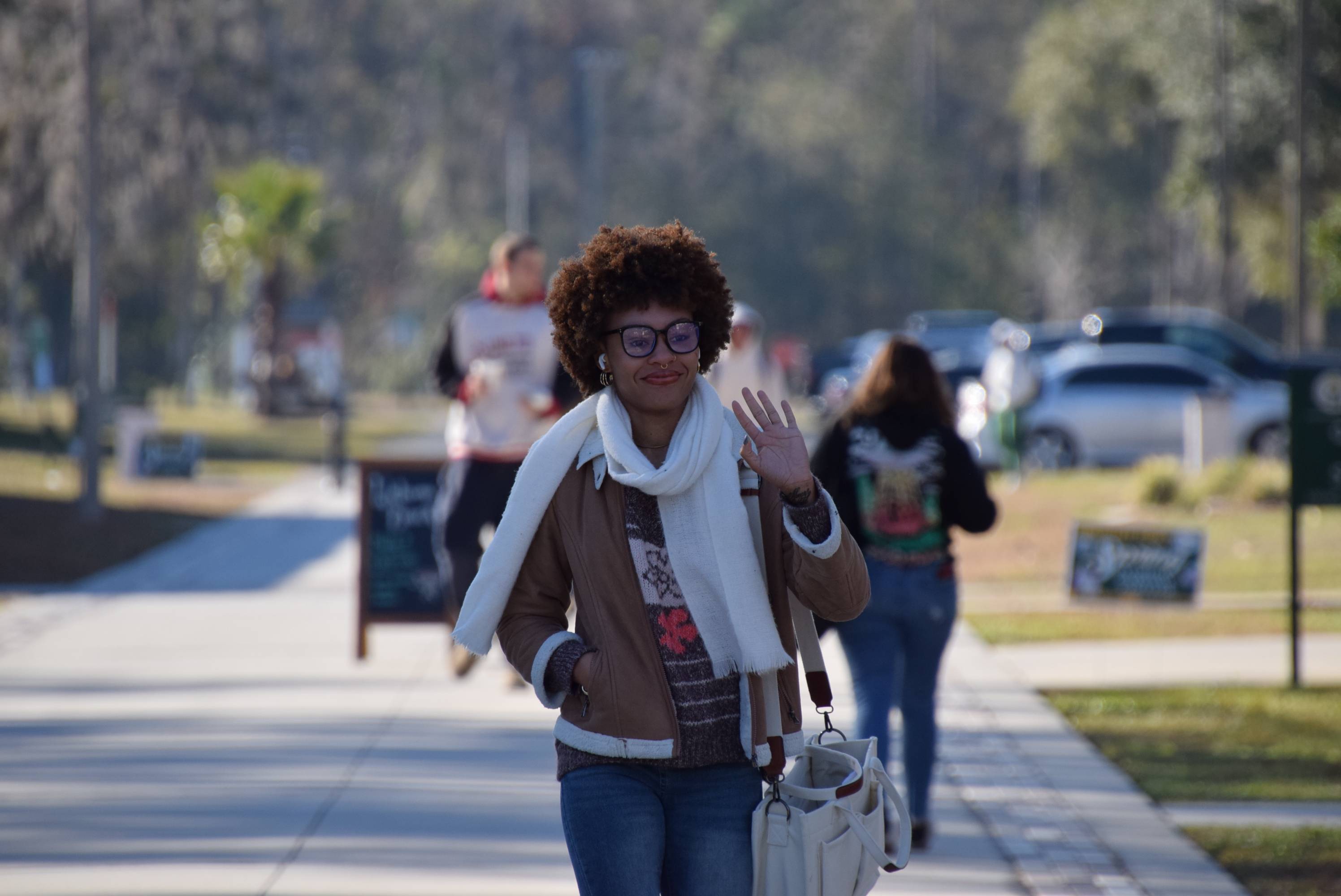 Girl in winter wear walking on sidewalk