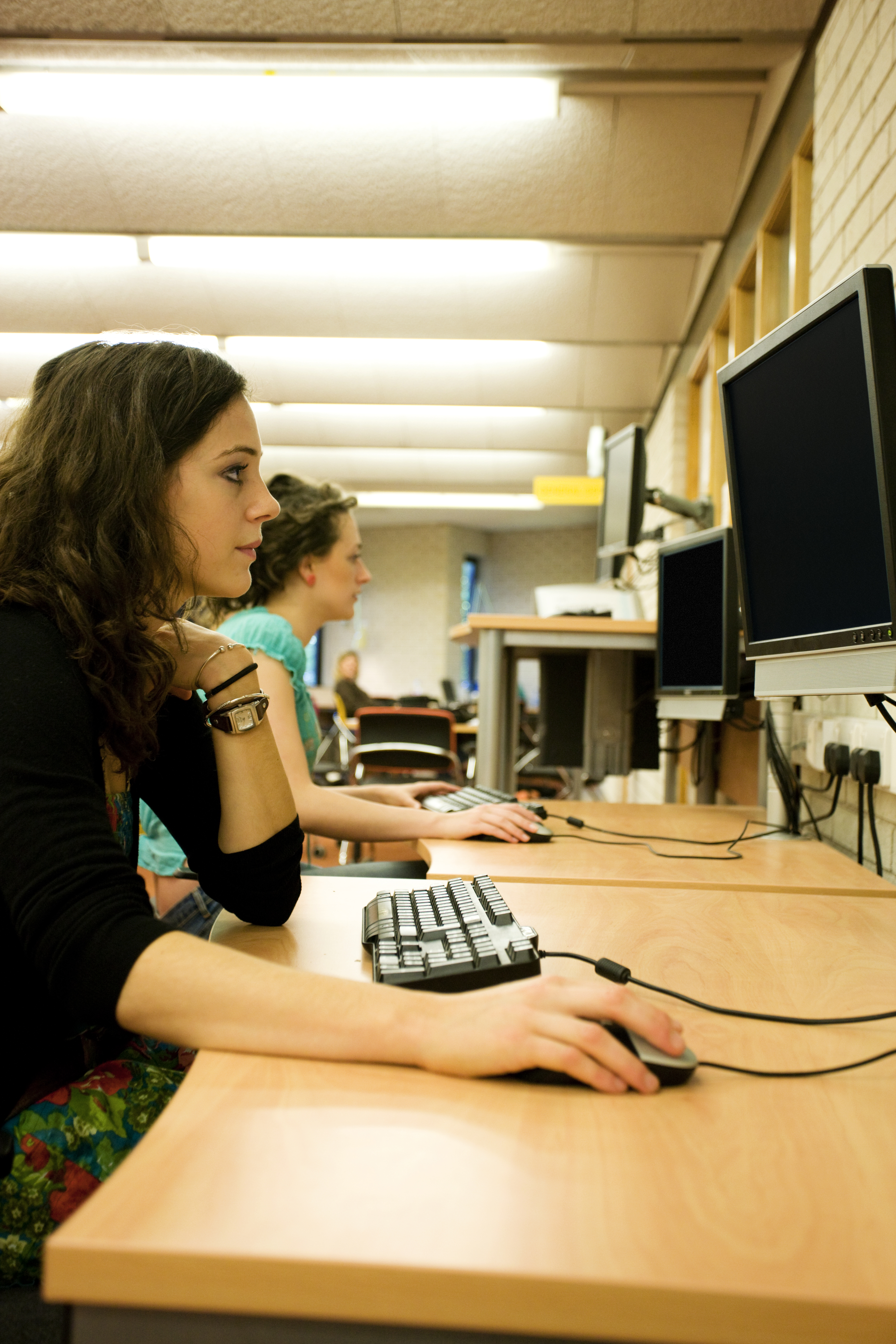 Profile view of student looking at a computer