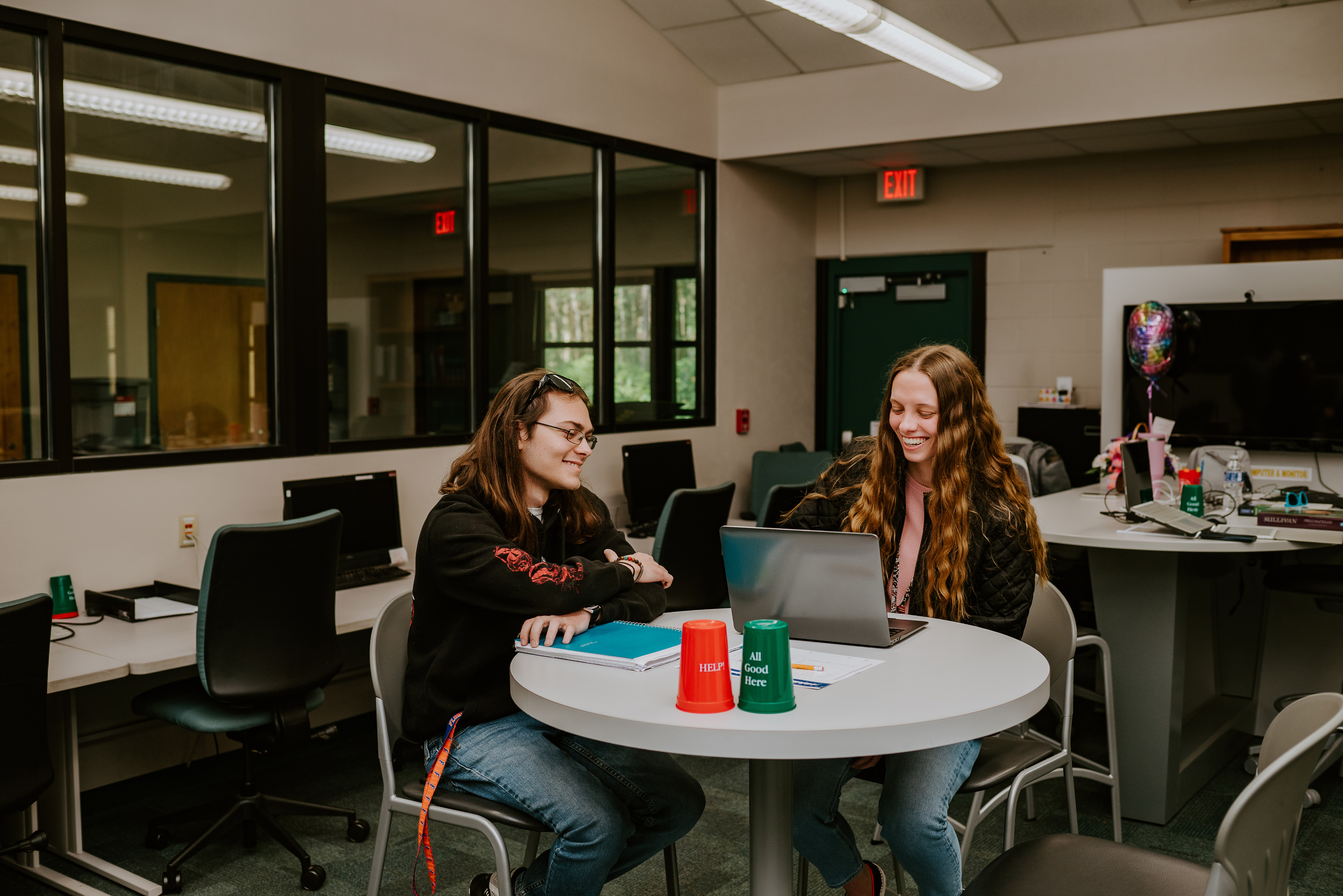 Student and student success coach working in student success center