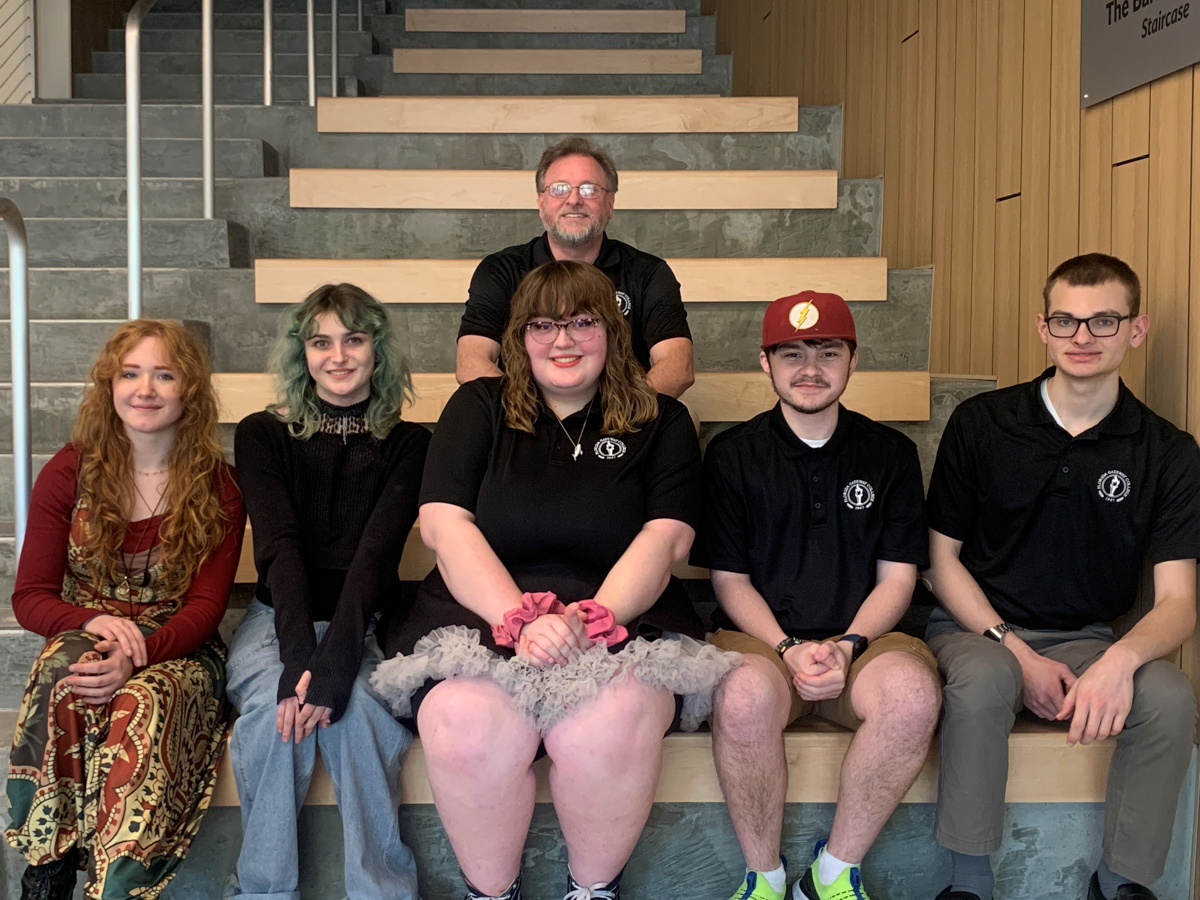 brain bowl team and coach sitting on steps