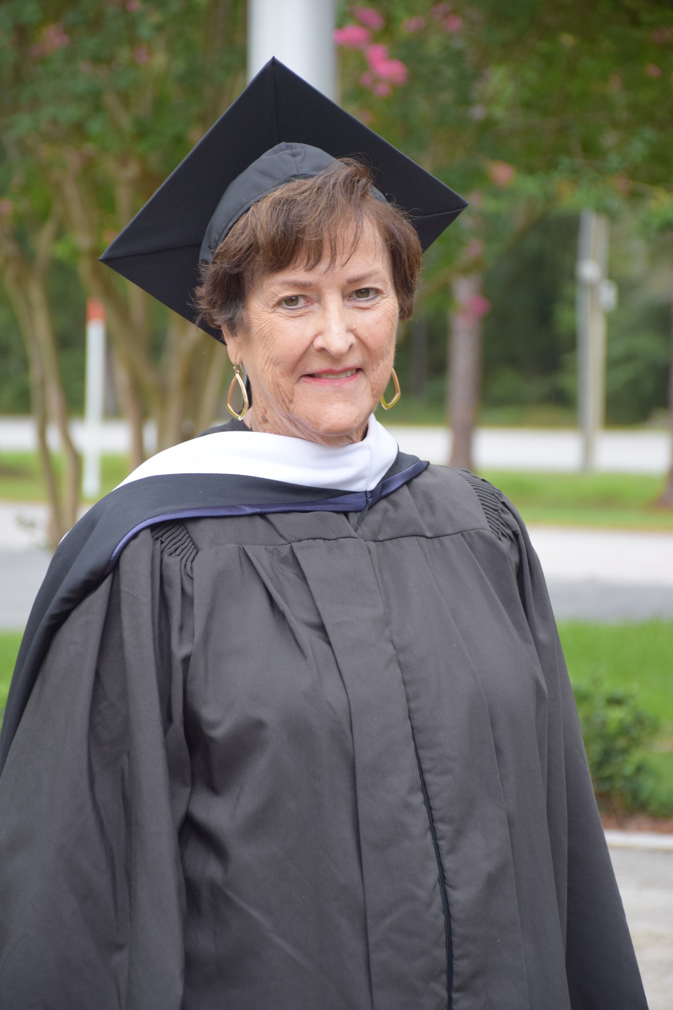Woman in commencement gown and cap.