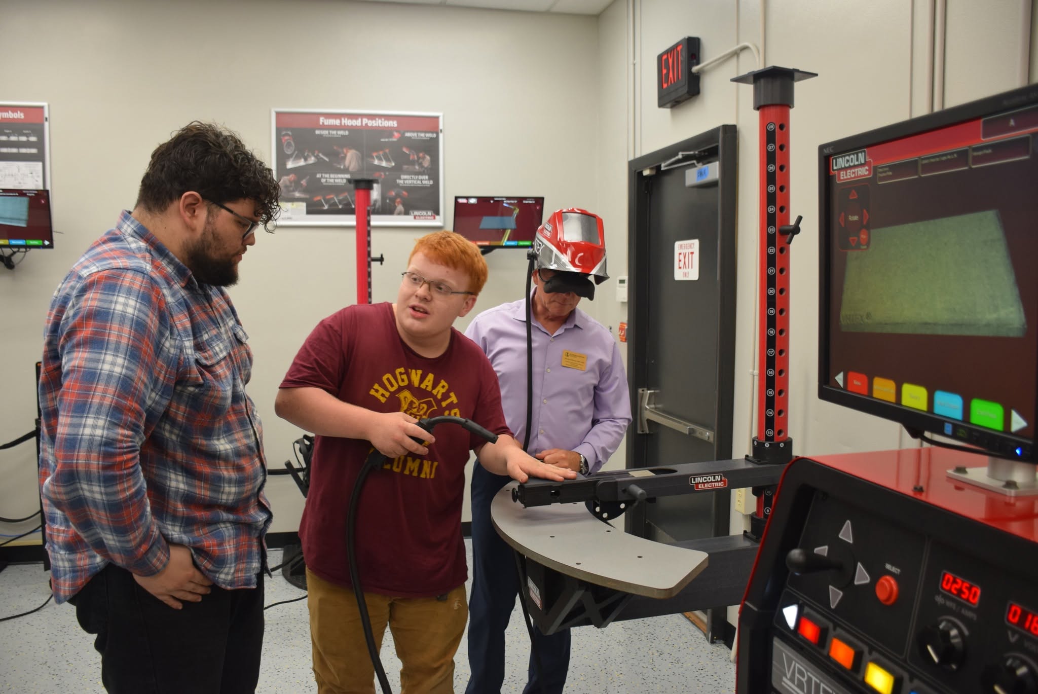 Students participate in hands-on welding training using a virtual welding simulator.